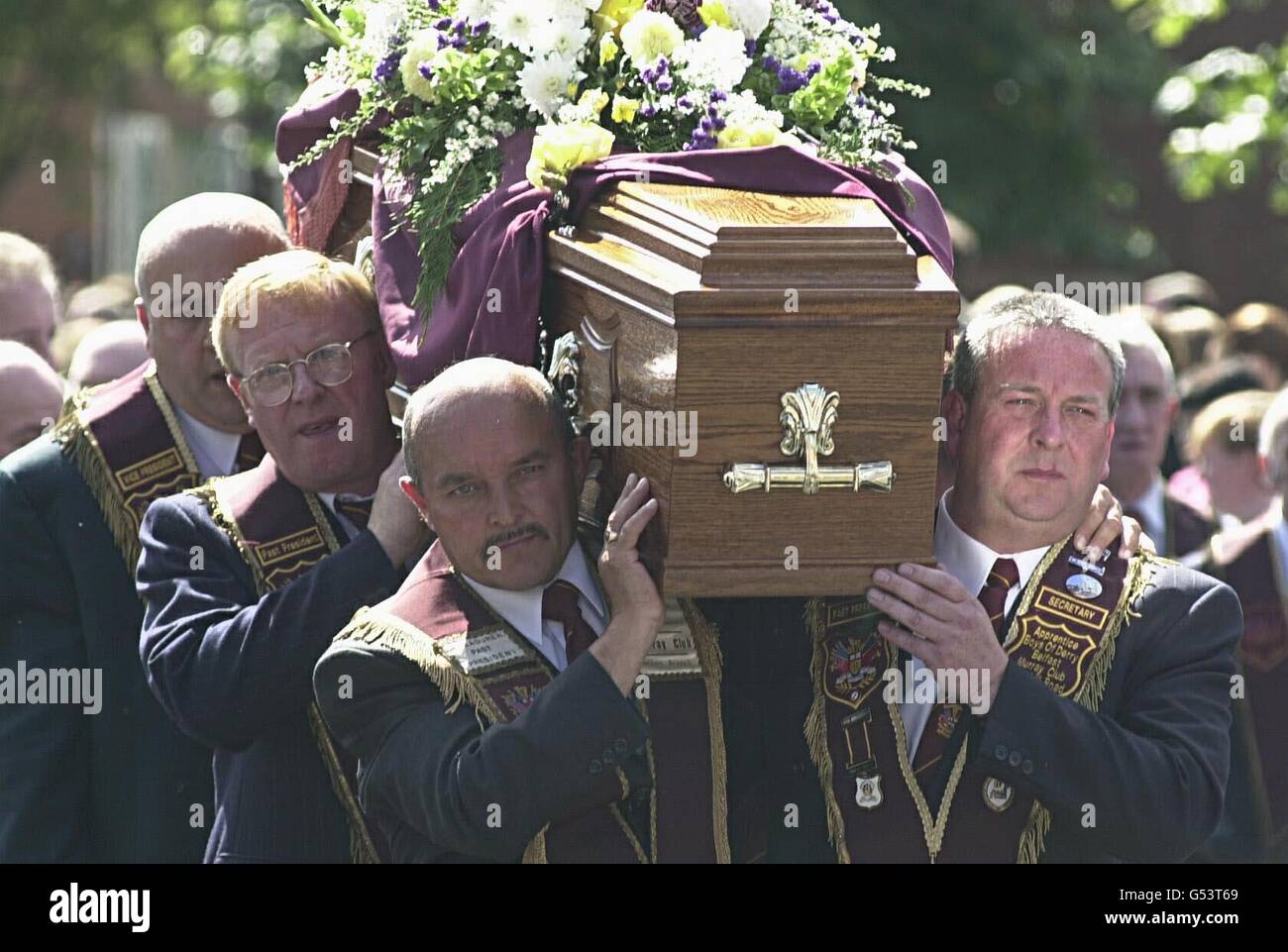 Mourners carry the coffin of Bobby Mahood from his home in Snugville