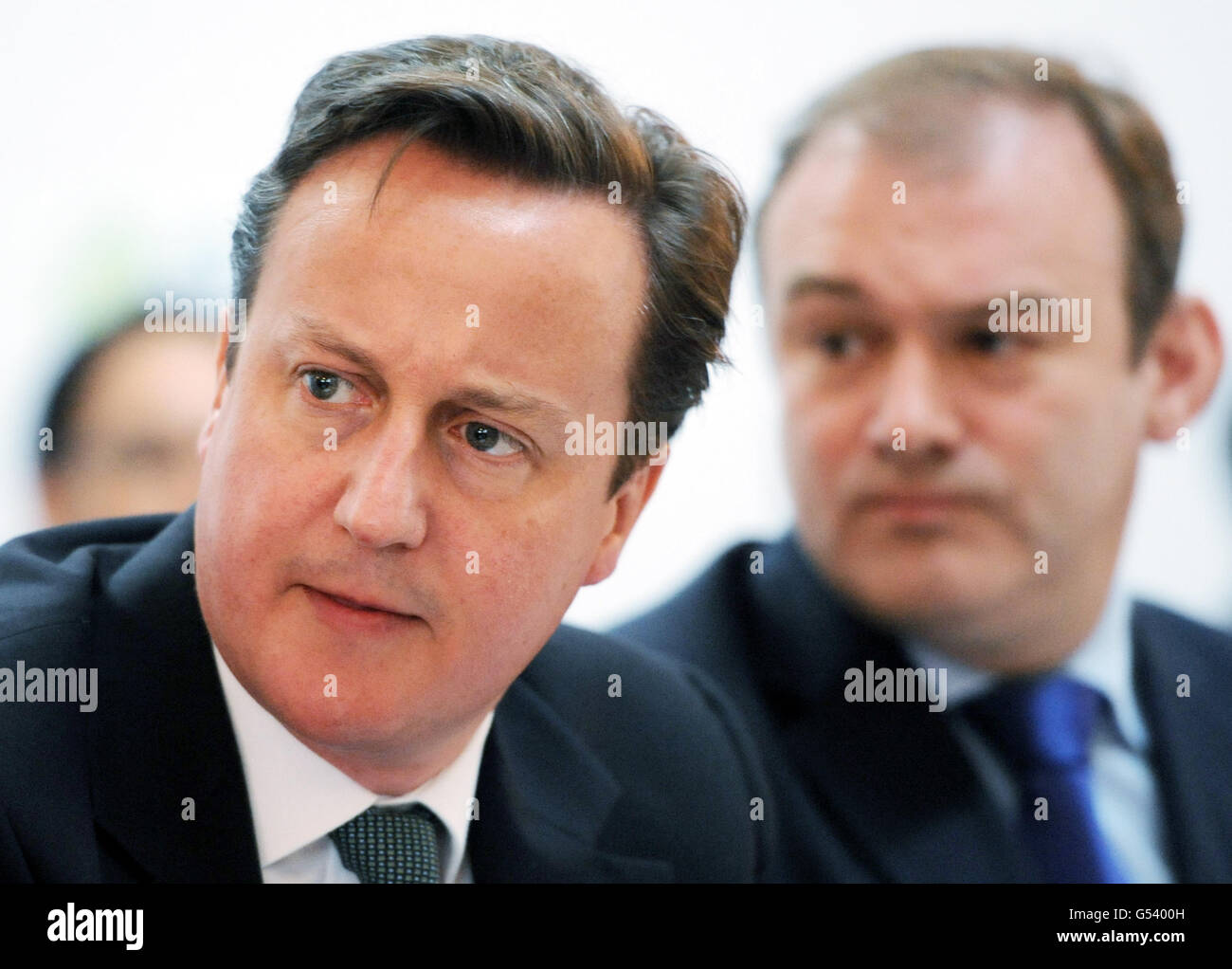 Prime Minister David Cameron speaks at the Clean Energy Ministerial Conference in London today alongside his Energy Secretary Ed Davey (right). Stock Photo