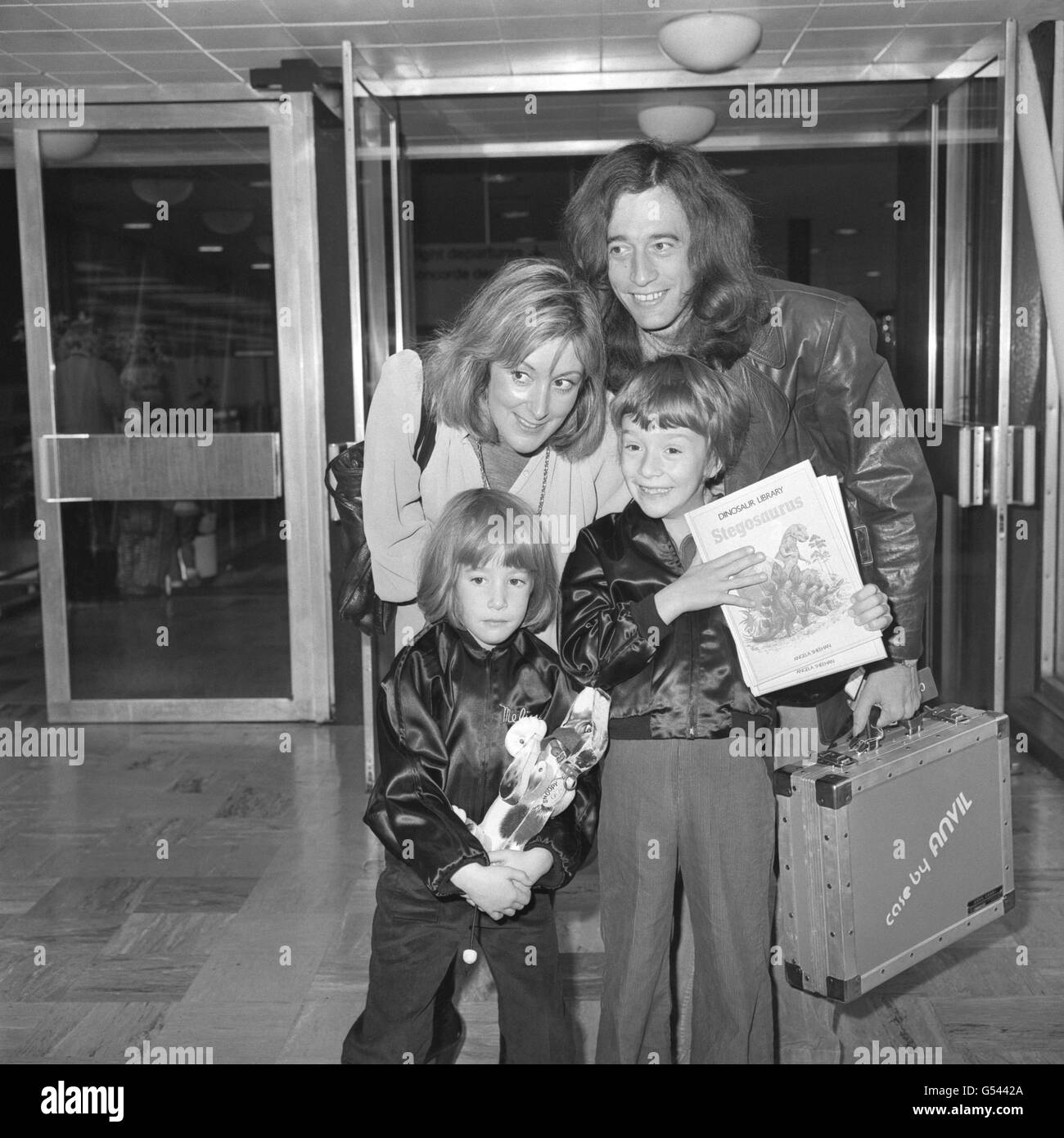 Robin Gibb of the Bee Gees pop group, his wife Molly and children, five year old Melissa, and seven year old Spencer, at London's Heathrow Airport prior to flying on Concorde to the United States. Stock Photo