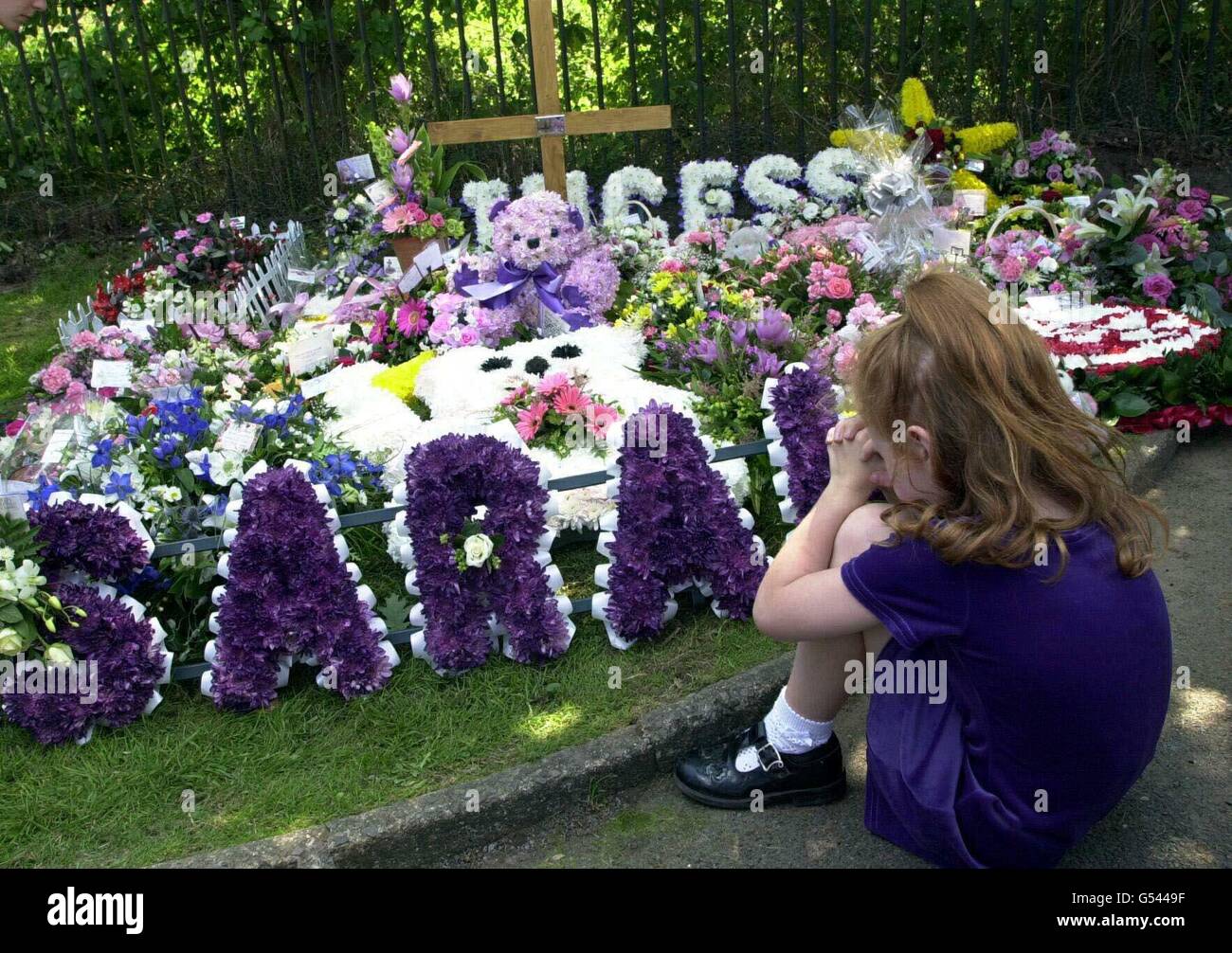 A young girl and a woman look at the flowers laid outside St Peter's Church, Hersham, Surrey after the funeral of murdered schoolgirl Sarah Payne. * Sarah was abducted on the 1st of July while playing with her brothers and sister near their grandparent's home in Littlehampton, West Sussex. Her body was discovered in a shallow grave two weeks later near Pulborough. It followed sixteen days of intense searching across the county. See PA story FUNERAL Sarah. PA Photo: Kirsty Wigglesworth Stock Photo