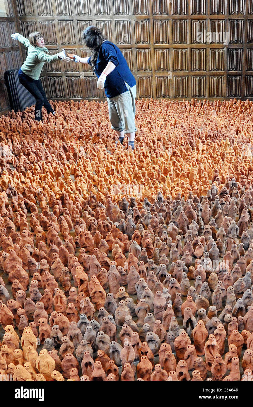 Local volunteers Deborah Westmancoat (right) and Frances Aitken help to set up Antony Gormley's installation - Field for the British Isles - consisting of 40,000 clay figures in three rooms at Barrington Court in Somerset. Stock Photo