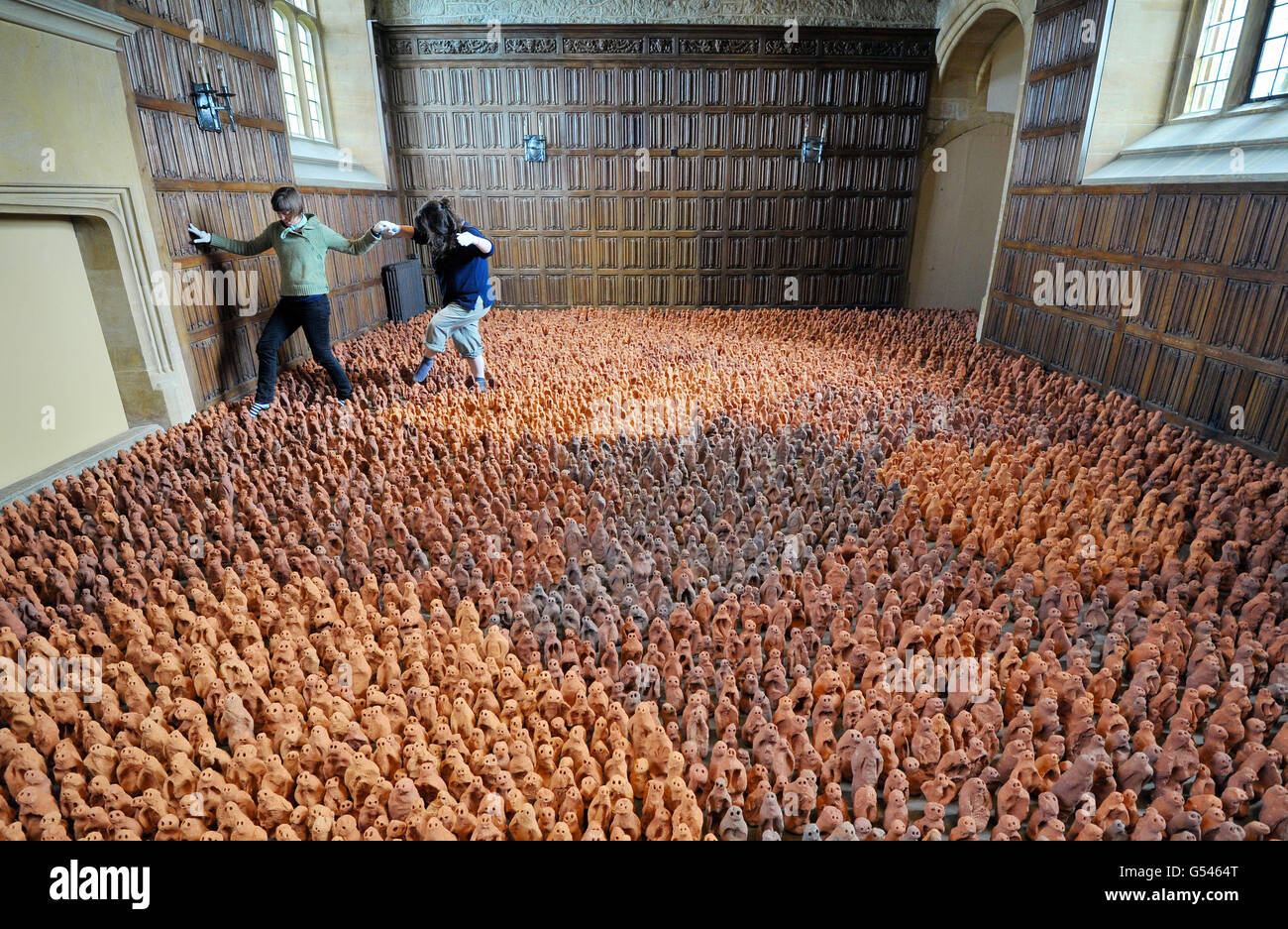 Local volunteers Deborah Westmancoat (right) and Frances Aitken help to set up Antony Gormley's installation - Field for the British Isles - consisting of 40,000 clay figures in three rooms at Barrington Court in Somerset. Stock Photo