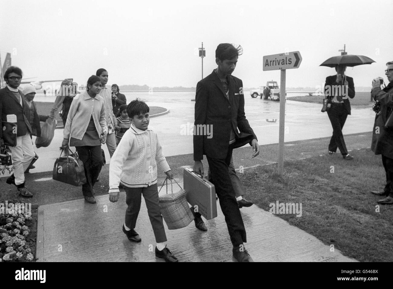 UGANDAN ASIANS 1972: Among the first arrivals to disembark from the specially chartered aircraft were these young men, women and children about to start a new life in this country away from the turmoil of Uganda. They are carrying some of their few belongings. Stock Photo