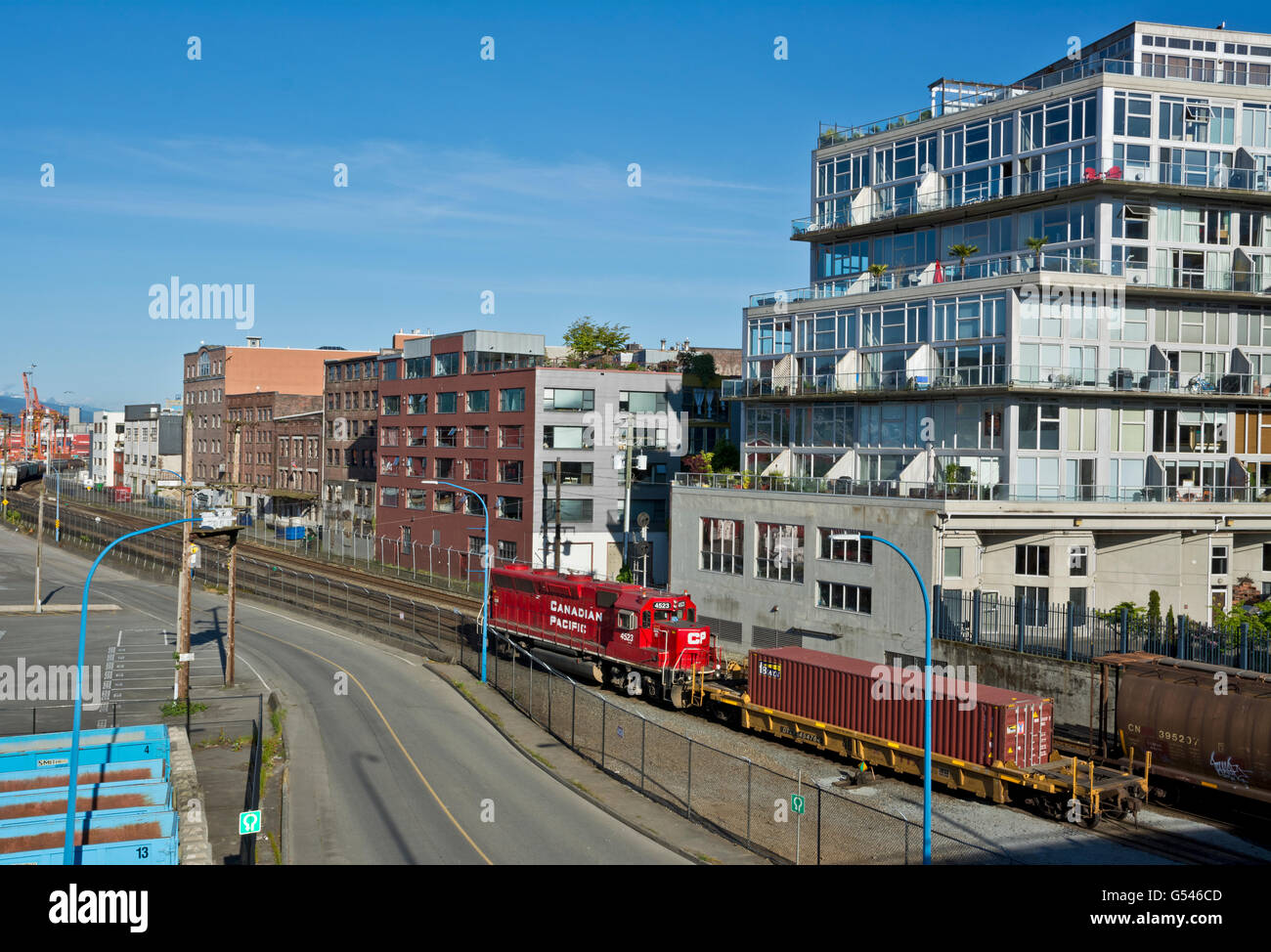 Industrial area with apartments condos by the train tracks in Vancouver's Downtown Eastside Railtown neighourhood Stock Photo