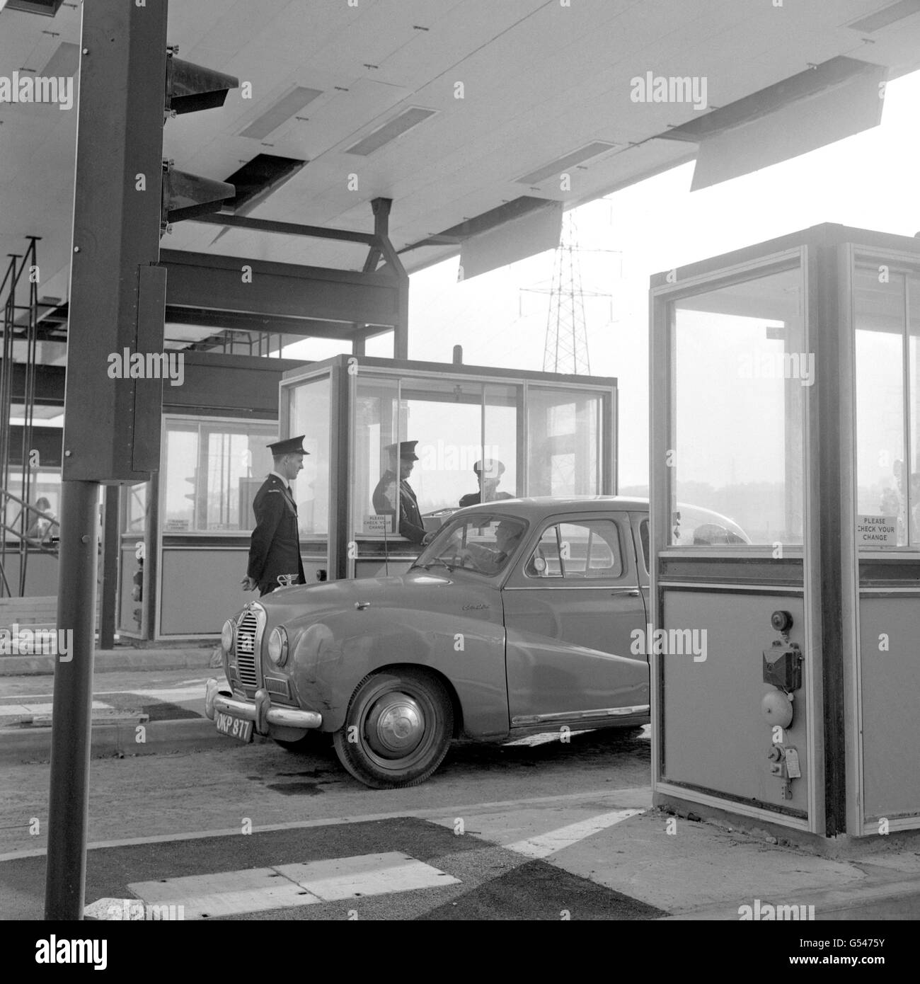 An Austin Somerset car draws up at one of the new toll gate booths near