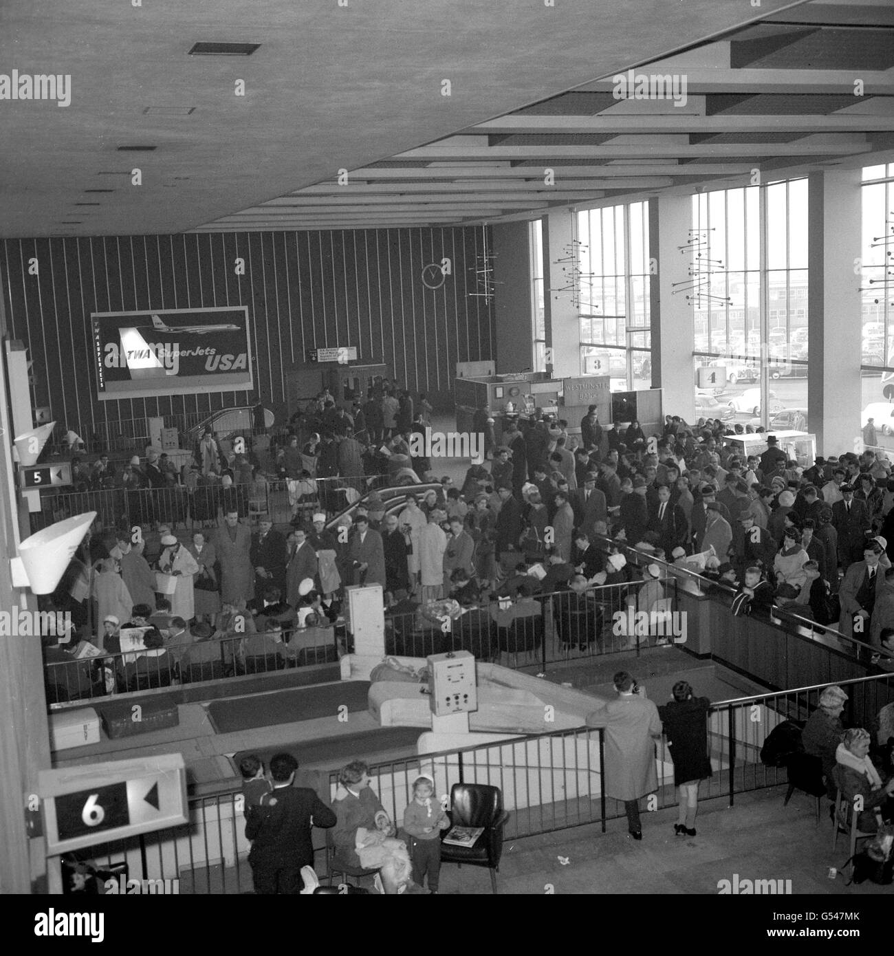 Happy Christmas crowds jostle their way through one of the passenger buildings at Heathrow Airport before leaving by air for many parts of the Continent for the holiday period. Stock Photo