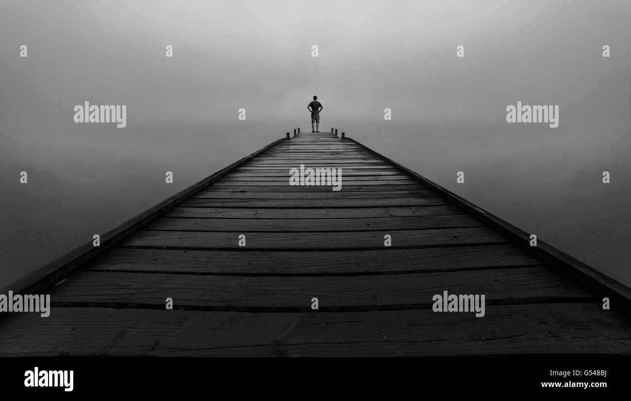 Lonely man standing Black and White Stock Photos & Images - Alamy