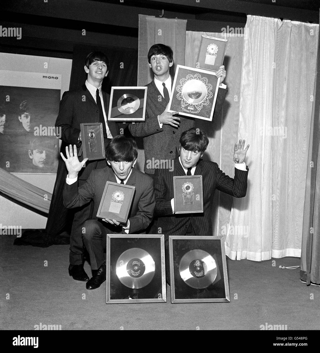 The Beatles, pictured at EMI House Manchester Square, London, with a hoard of silver discs. They were presented with two silver LPs to mark the quarter-million plus sales of their first LP 'Please Please Me' and their new one 'With the Beatles' as well as for their 'Twist & Shout' EP and 'She Loves You'. Left to right: Ringo Starr, George Harrison, Paul McCartney and John Lennon. Stock Photo