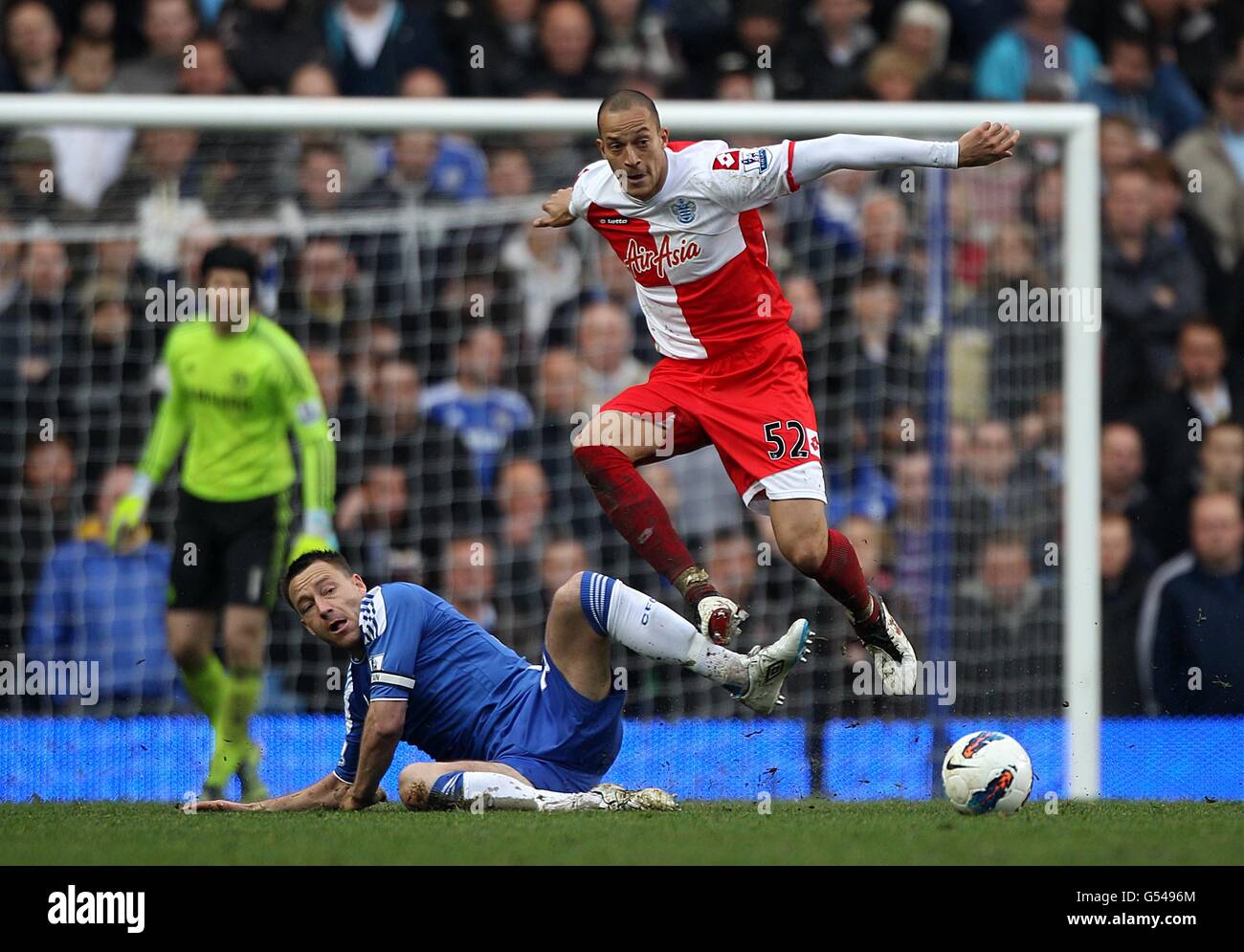 Queens Park Rangers' Bobby Zamora jumps the tackle from Chelsea's John Terry Stock Photo