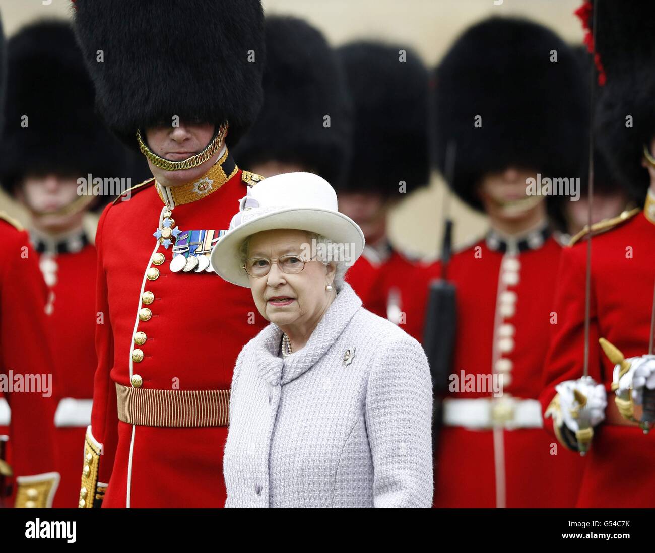 Queen Elizabeth II inspects the guards during a ceremony to present new
