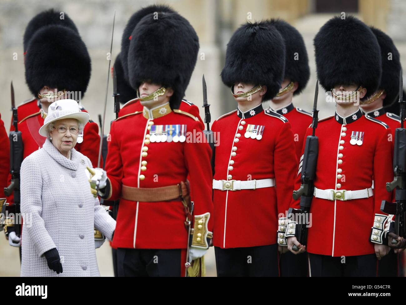 Queen Elizabeth II inspects the guards during a ceremony to present new