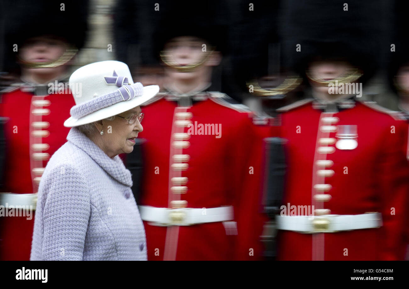Queen Elizabeth II inspects the guards during a ceremony to present new