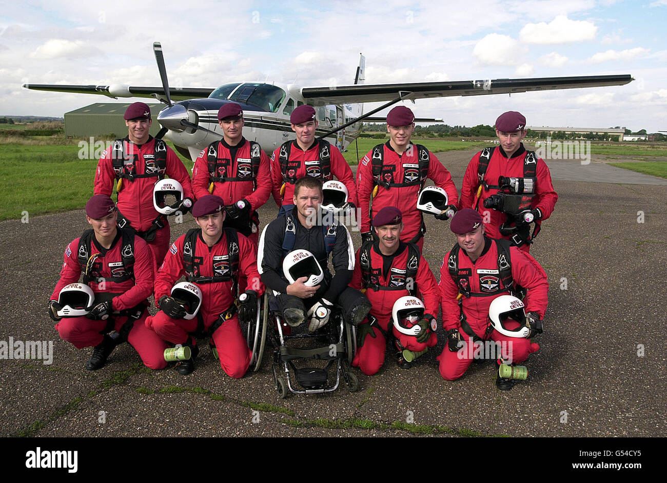 Double amputee Alastair Hodgson (dart suit) joins the Army Red Devils Display team before completing a freefall jump at Langer airfield, Nottinghamshire. Hodgson, 29, lost both legs in a bomb blast while serving in Northern Ireland. * and becomes Britain's first double amputee to do an accelerated free-fall parachute jump when he leapt 14,000ft from an aircraft. Stock Photo