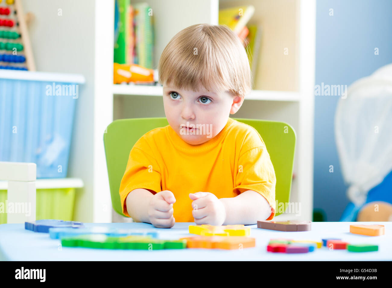 kid playing with building blocks at home or kindergarten Stock Photo