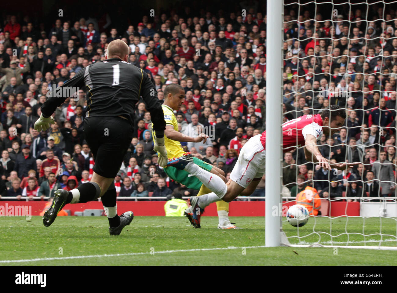 Arsenal's Robin Van Persie (right) falls over in the penalty area after being challenged by Norwich City's Kyle Naughton, during their Barclays Premier League fooball match at the Emirates Stadium in north London. PRESS ASSOCIATION Photo. Picture date: Saturday May 5, 2012. Photo credit should read: Yui Mok/PA Wire Stock Photo