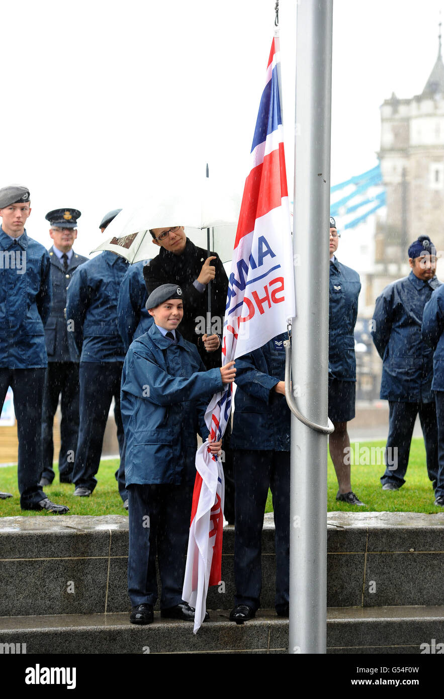 Cadets stand in the pouring rain as they raise the Armed Forces flag during a flag-raising ceremony at City Hall, London, to mark the start of a week of celebrations ahead of Armed Forces Day on June 25. Stock Photo