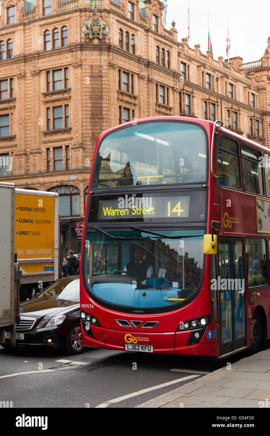 LONDON - OCTOBER 19, 2015: Famous red double decker bus in front of the harrods store in the knightbridge district Stock Photo
