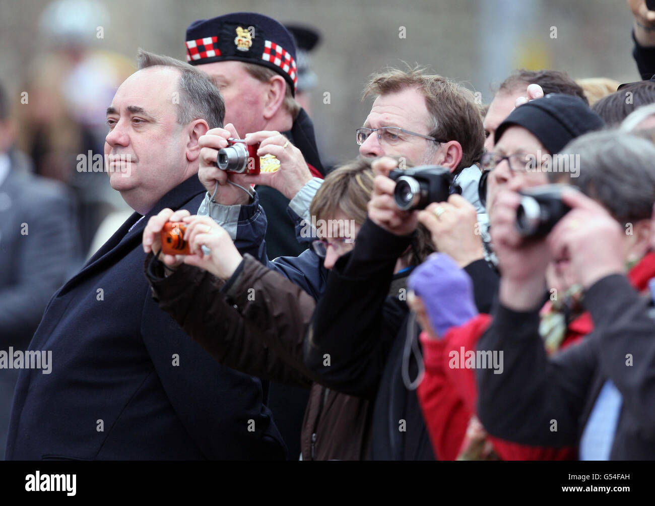 First minister Alex Salmond looks on as a parade of Armed Forces personnel marches past on the Royal Mile, Edinburgh. Stock Photo
