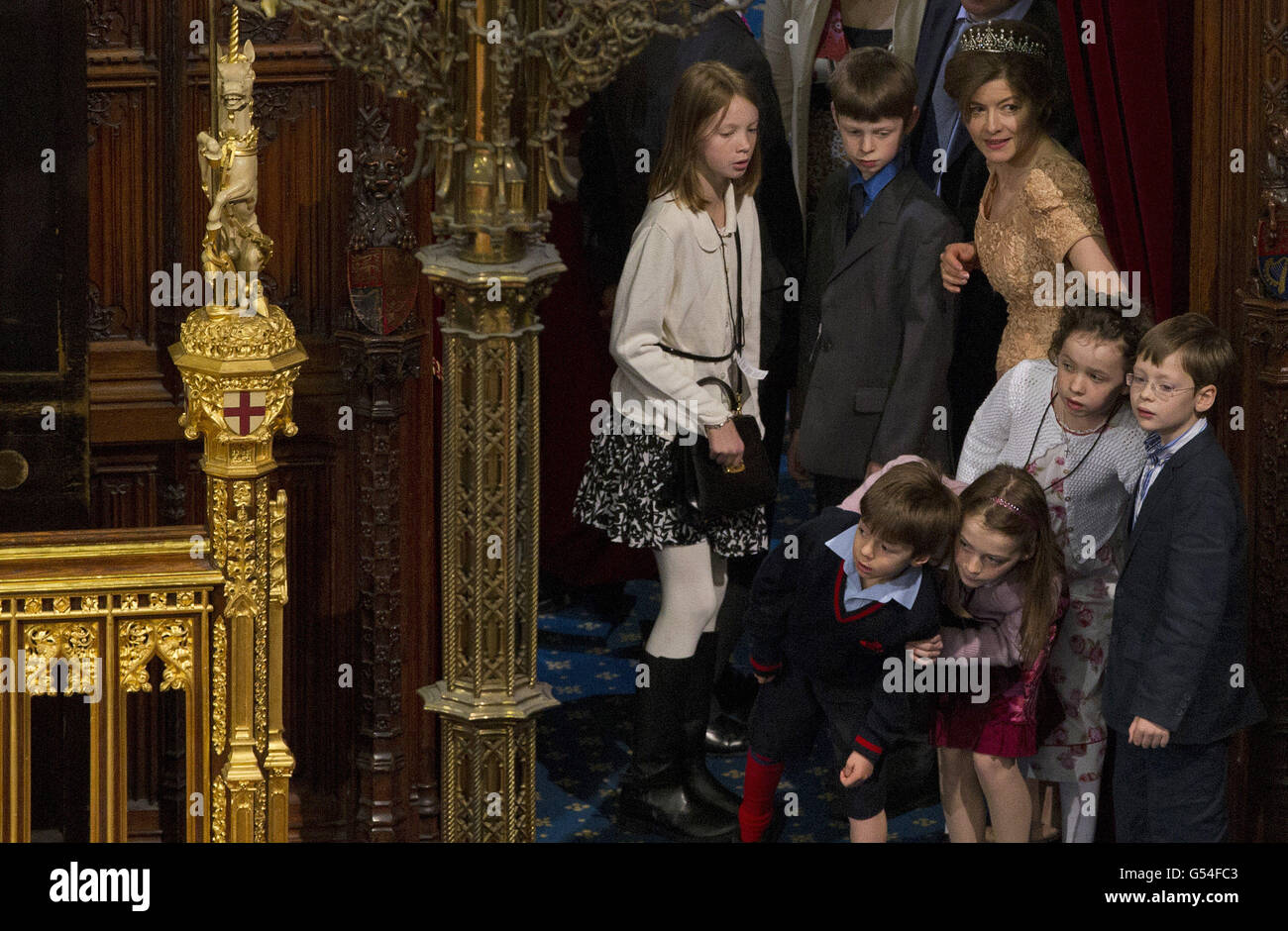 Children and family members of the House of Lords peer round the entrance to look at the scene