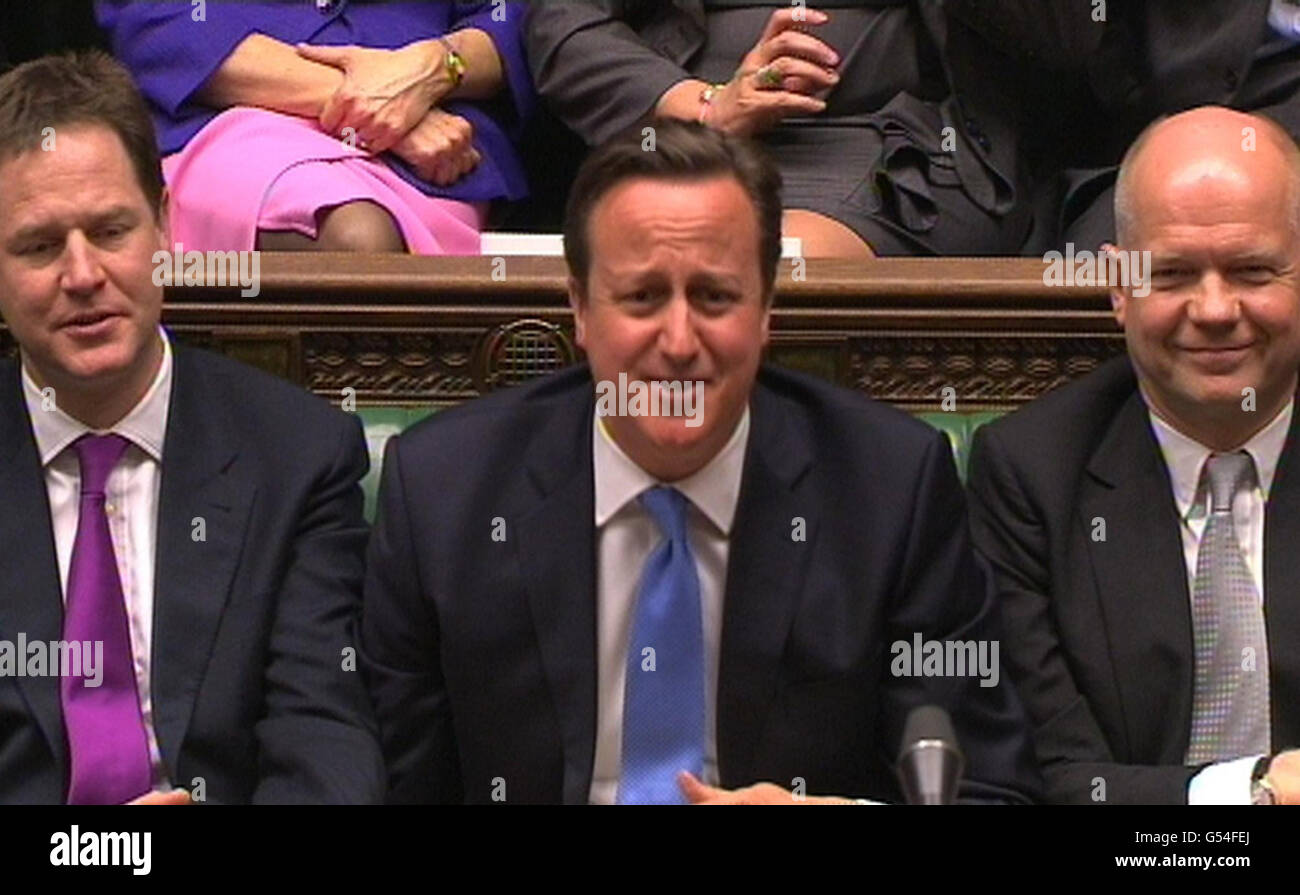 (left to right) Nick Clegg, David Cameron and William Hague react during Labour Party leader Ed Miliband speech during the debate on the Queen's Speech in the House of Commons, London. Stock Photo