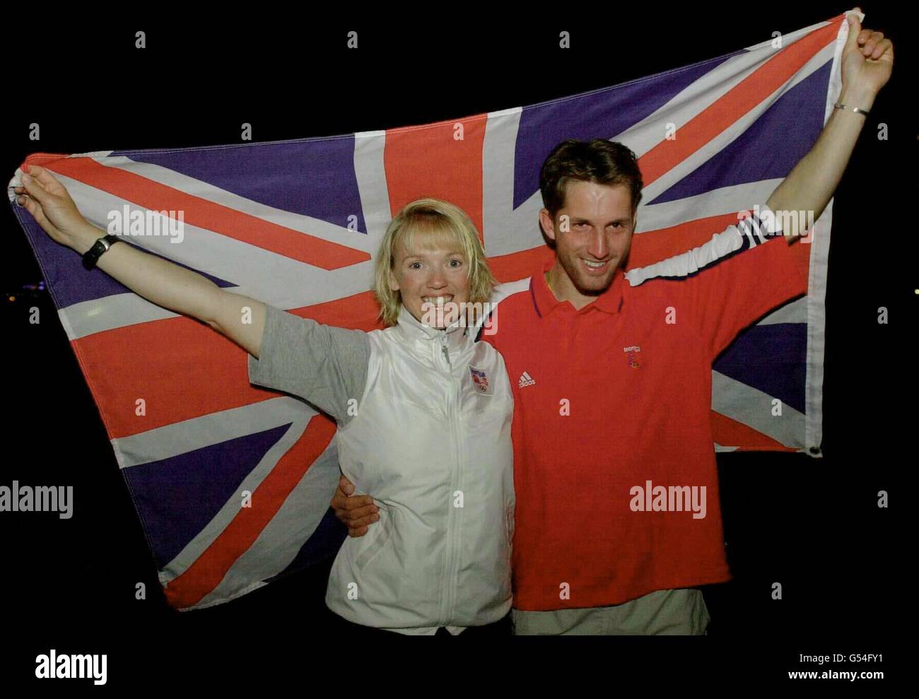 Great Britain's Shirley Robertson and Ben Ainslie celebrate their Gold medal success at the Olympic Games in Sydney. Robertson won the Women's Europe Sailing class while Ainslie took first place in the Laser Sailing class. Stock Photo