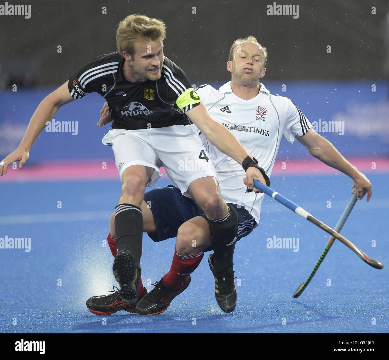 Great Britain's Glenn Kirkham is challenged by Germany's Maximillian Muller during the Visa International Invitational Hockey Tournament at the Riverbank Arena, London. Stock Photo