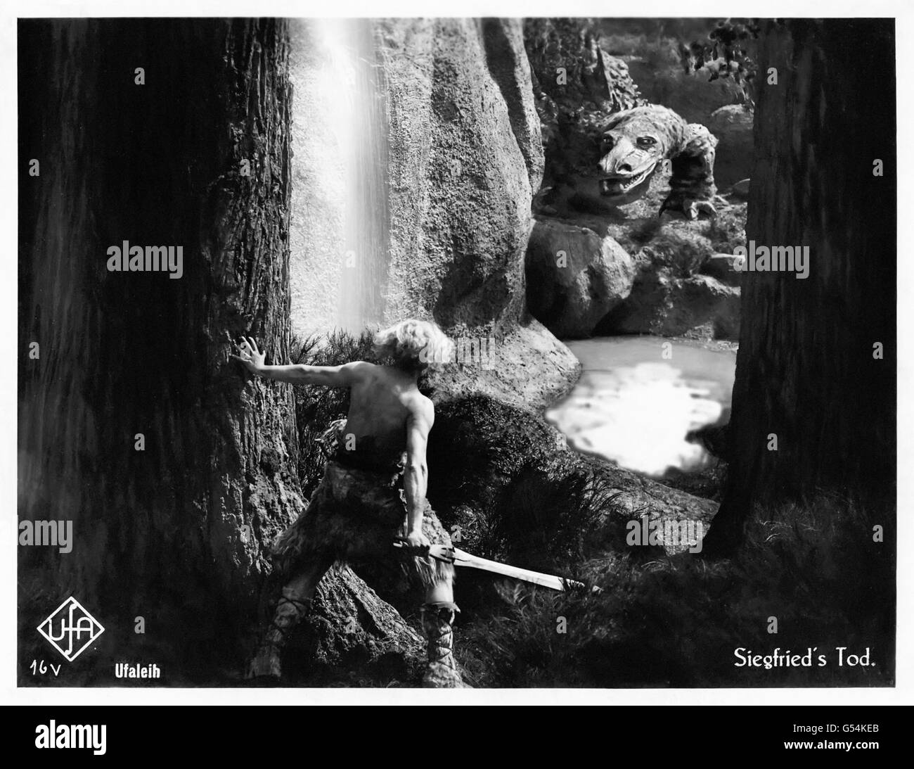 ‘Die Nibelungen: Siegfried’ 1924 German fantasy film directed by Fritz Lang (1890-1976) original lobby card showing Siegfried’s (Paul Richter) encounter with the magical dragon in the wood. Stock Photo