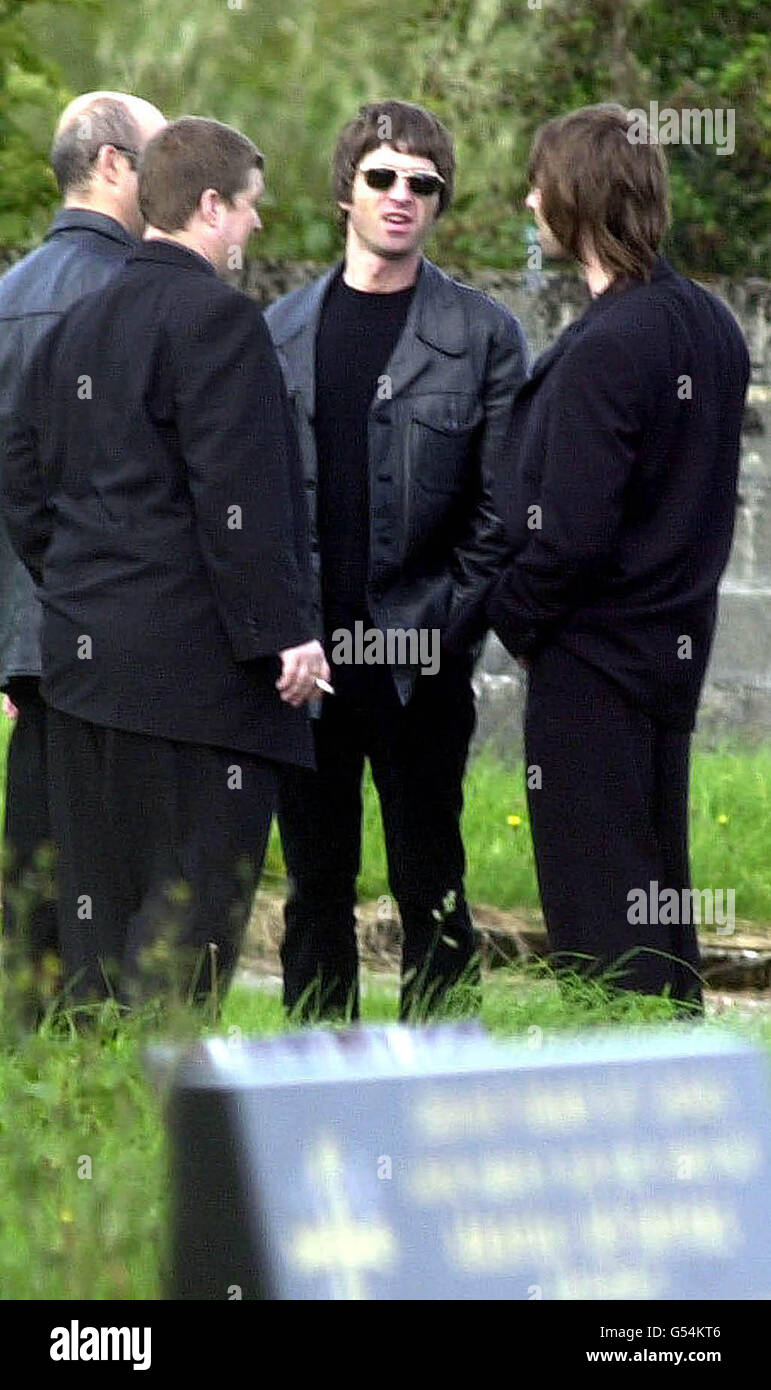 Oasis pop stars Noel (facing camera) and Liam (R) with their brother Paul(left, nearest camera) and a mourner in the cemetry after the funeral of the brothers' grandmother Margaret Sweeney at St. James Church, Charlestown, Co. Mayo. Stock Photo