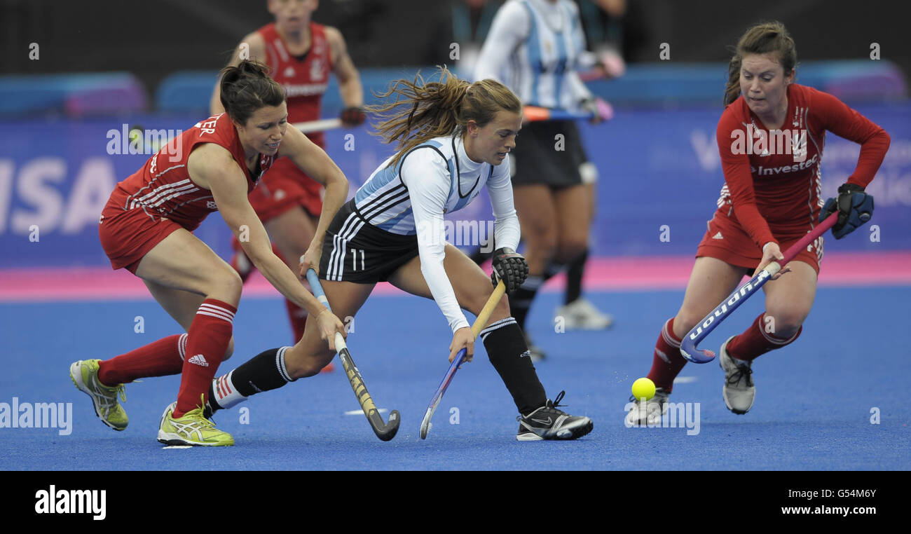 Argentina's Carla Rebecchi is challenged by Great Britain's Anne Panter (left)and Laura Unsworth during the Visa International Invitational Hockey Tournament at the Riverbank Arena, London. Stock Photo