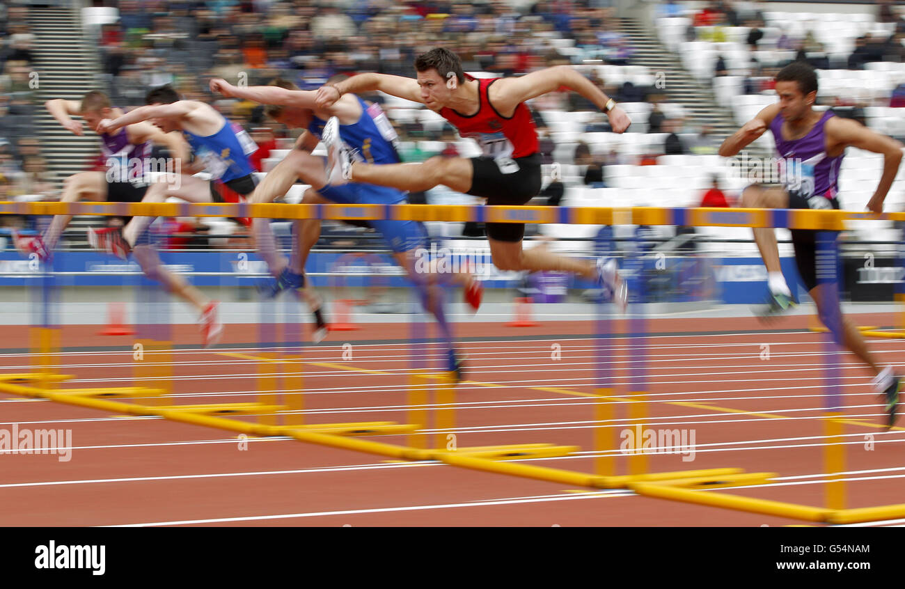 Andrew Pozzi (centre in red) clears a hurdle on his way to winning gold