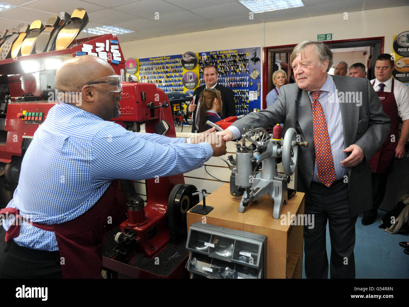 Justice Secretary Clarke shakes hands with a prisoner (name not