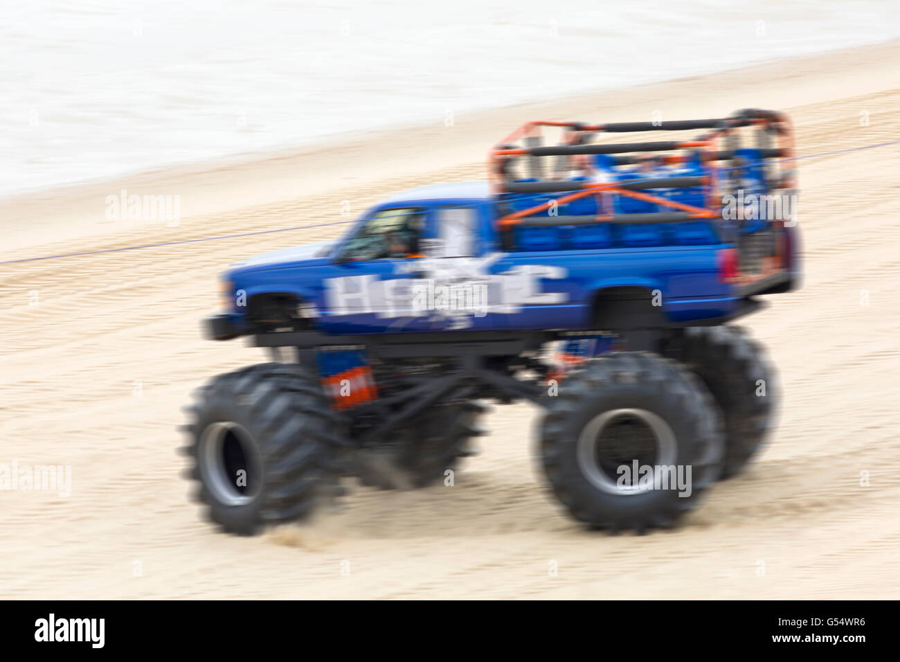 Visitors enjoying a ride on monster truck Havoc on the first day of the Bournemouth Wheels Festival 2016, Bournemouth Dorset UK in June - blurred Stock Photo