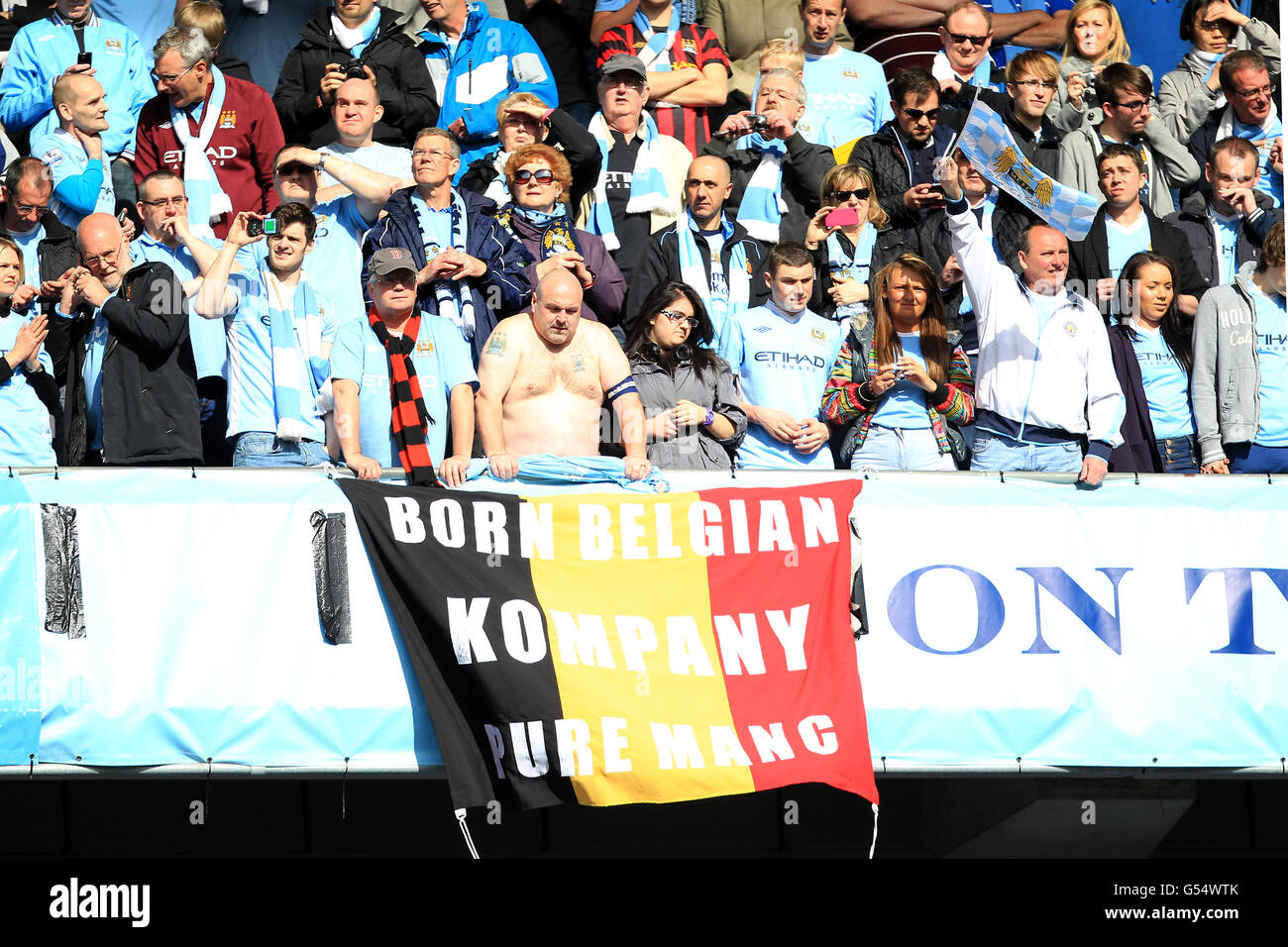 Manchester City fans with a banner that reads 'Born Belgian, Pure Manc, Kompany' Stock Photo