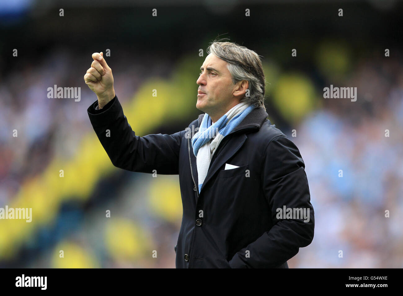 Manchester city manager roberto mancini waves an imaginary card hi-res ...