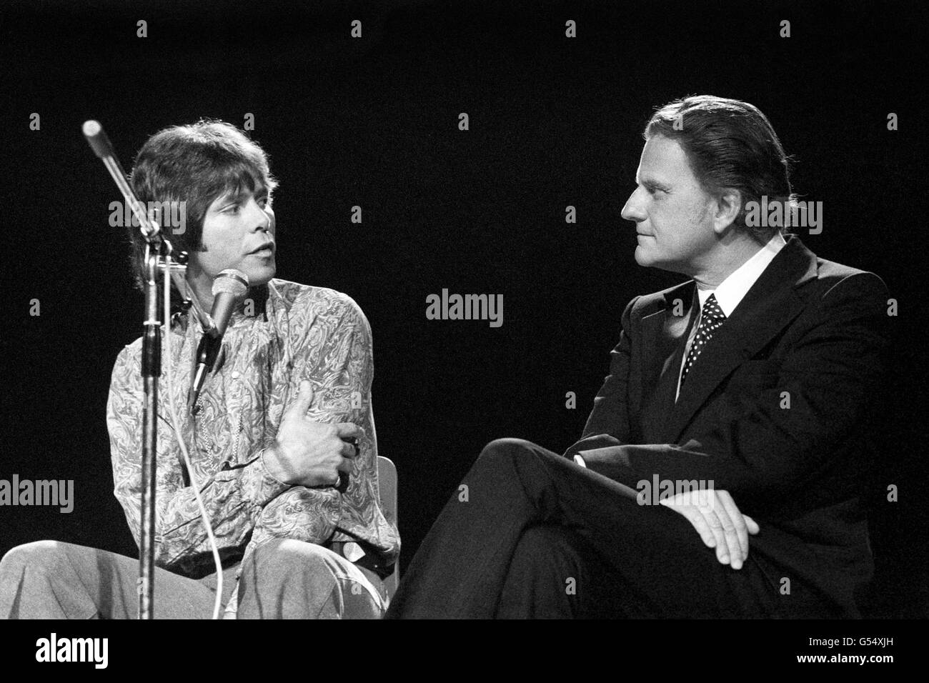 Evangelical preacher Billy Graham, who is on a short visit to Britain, on a platform at Earl's Court alongside pop star Cliff Richard. Stock Photo