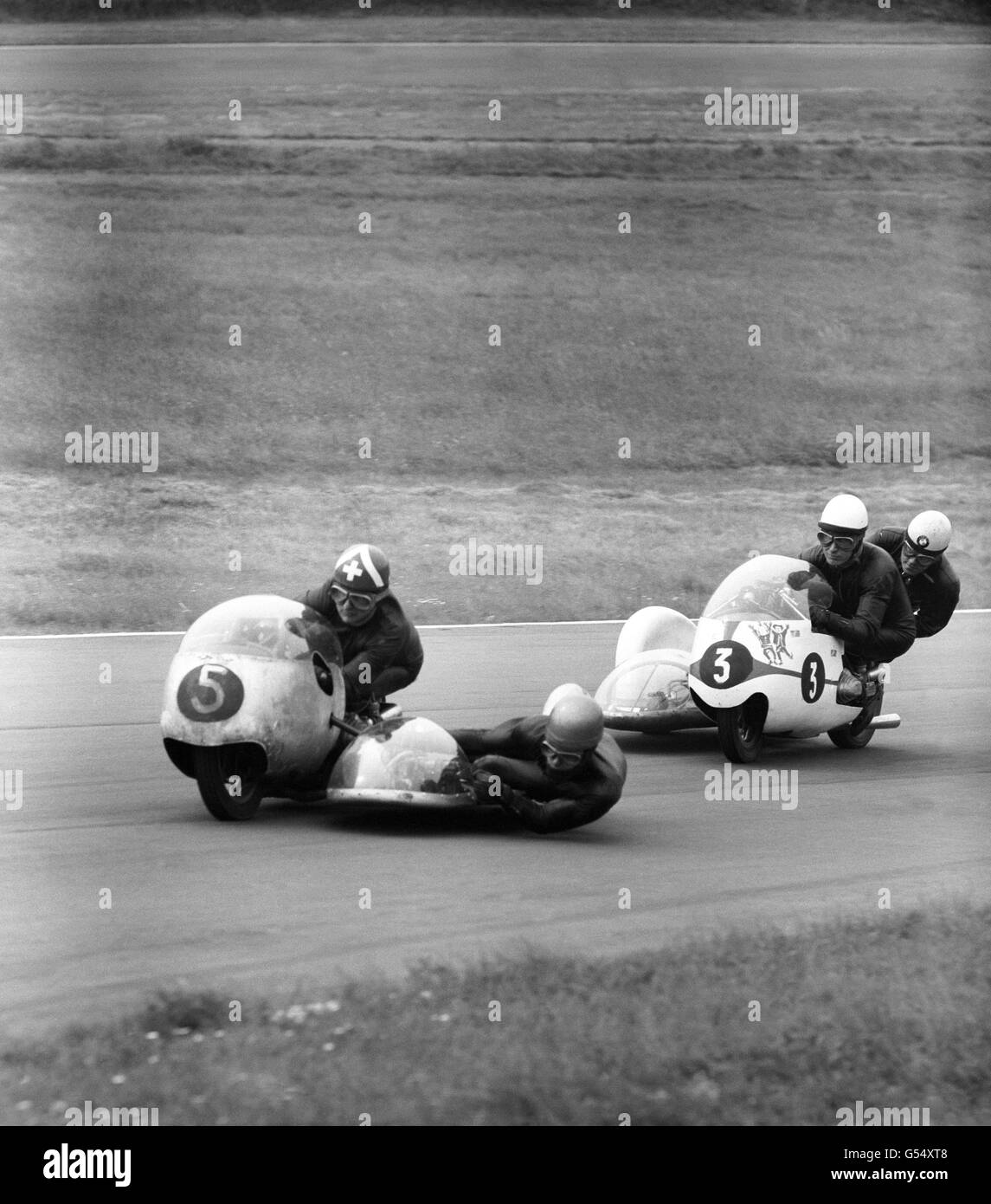 Florian Camathias (Switzerland) (5) with passenger Alfred Herzig on a 493 FCS followed by world champion Max Deubel (3) with passenger Emil Horner on a 500 BMW. Stock Photo