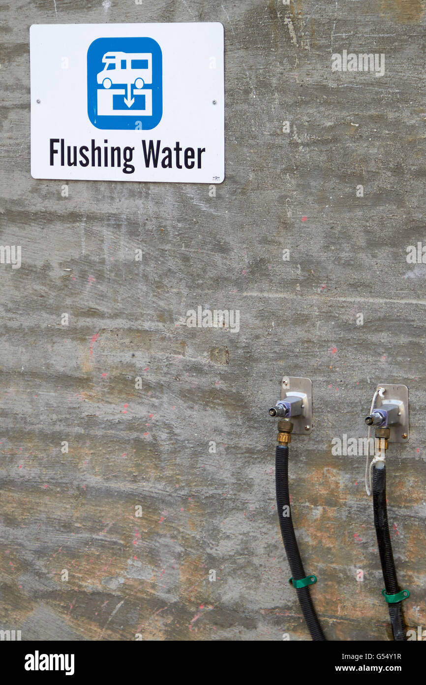Flushing water outlet and sign on camping ground Stock Photo