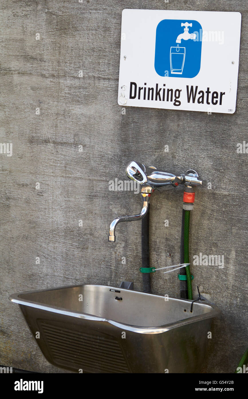 Drinking water outlet and sign on camping ground Stock Photo