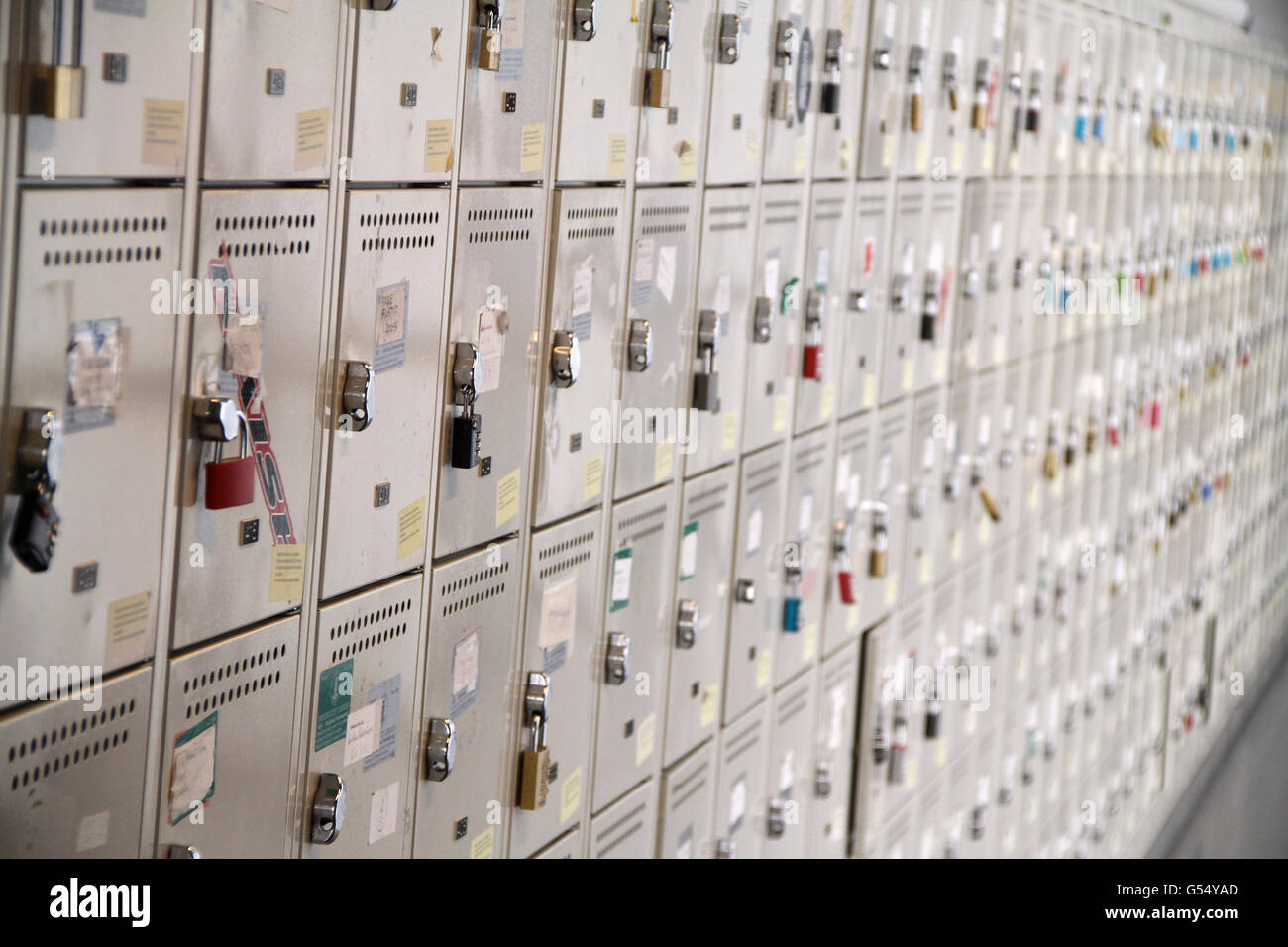 A perspective view of a stack of white metal school lockers, some with ...