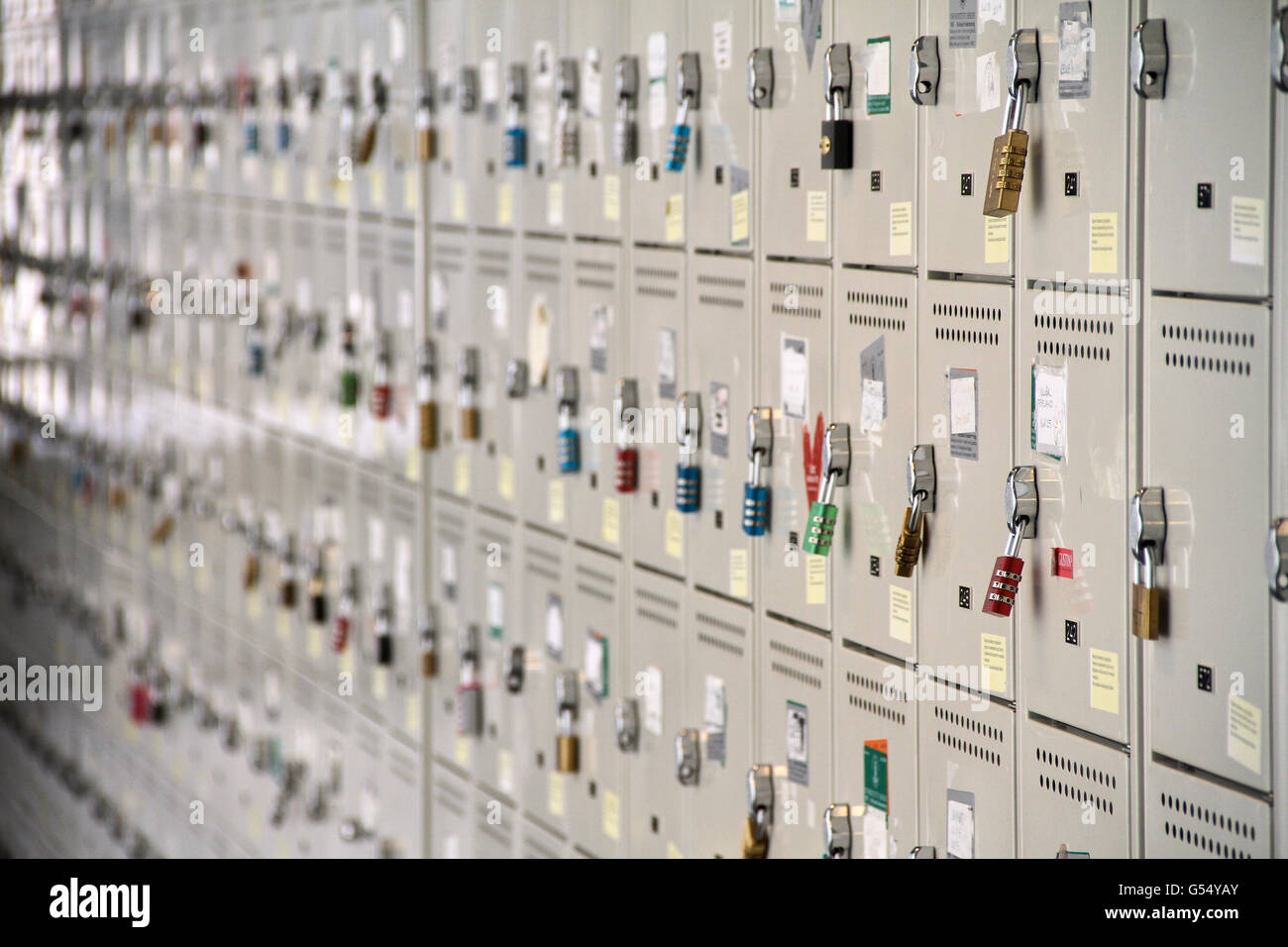 A perspective view of a stack of white metal school lockers, some with ...