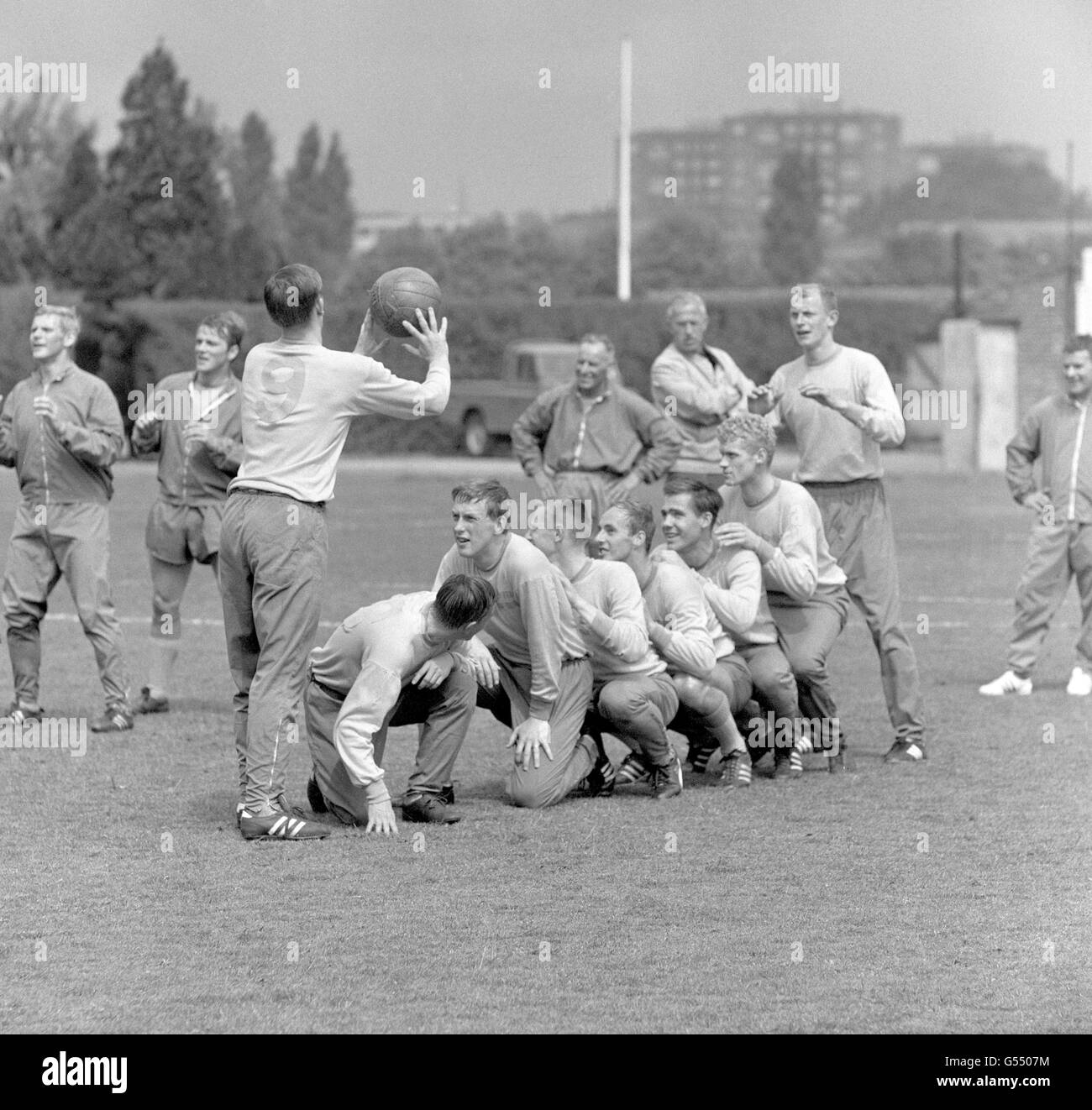 The Sweden team train at New Beckenham in preparation for their friendly against England. Thomas Nordahl throws the ball to goalkeeper Sven-Gunnar Larsson over a handful of players kneeling, including Glasgow Rangers Orjan Persson (second in line kneeling) Stock Photo