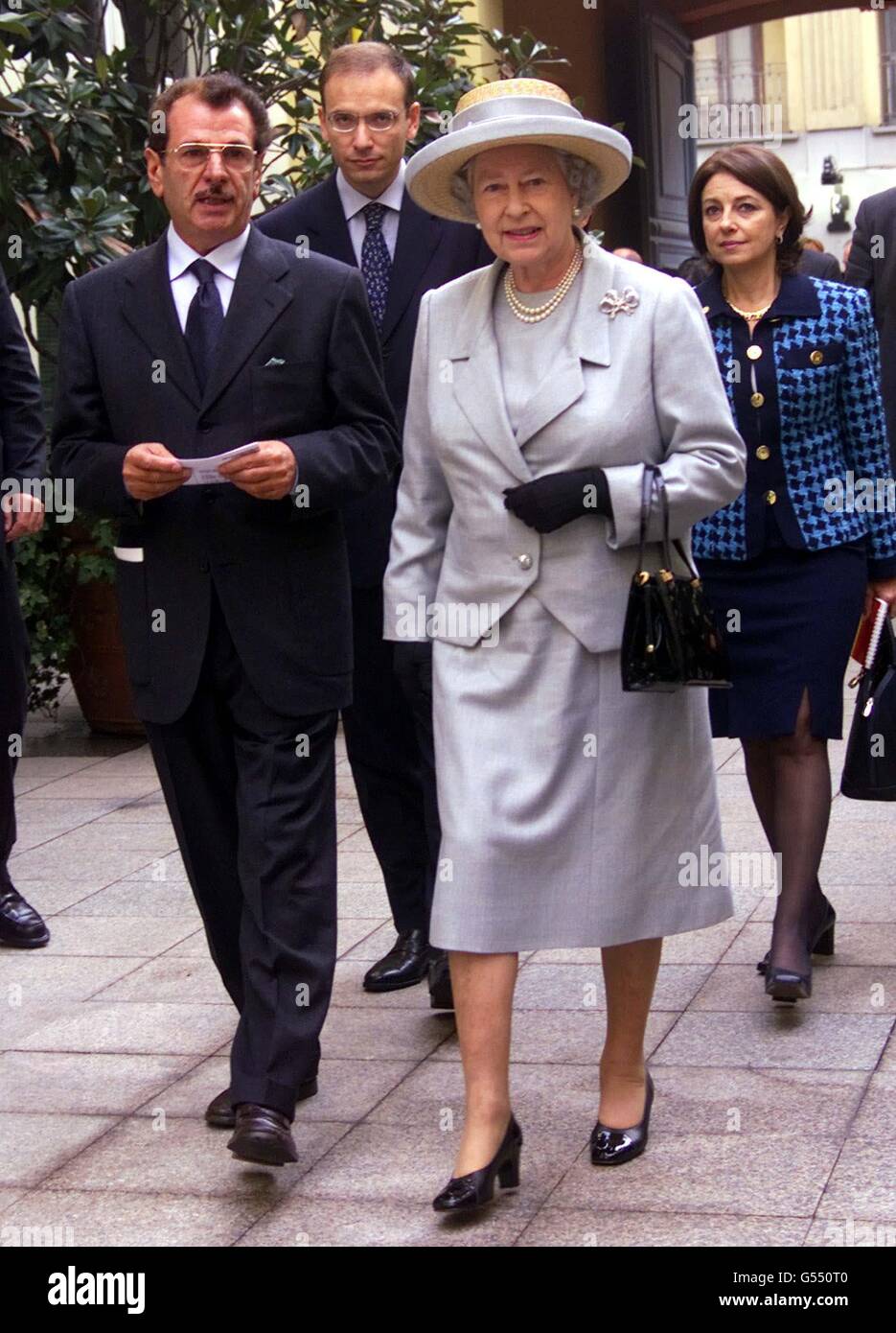 Britain's Queen Elizabeth II is flanked by Francesco Morelli, director of  the Institute and followed by Italian Industry minister Enrico Letta,  centre, during a visit to the European Institute of Design, in