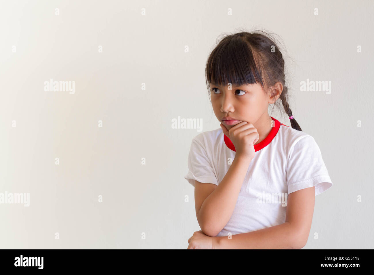 Asian girl kid is thinking for something Stock Photo