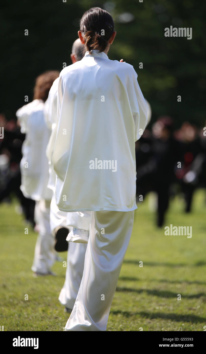 martial arts Tai Chi with shiny white silk dress during the