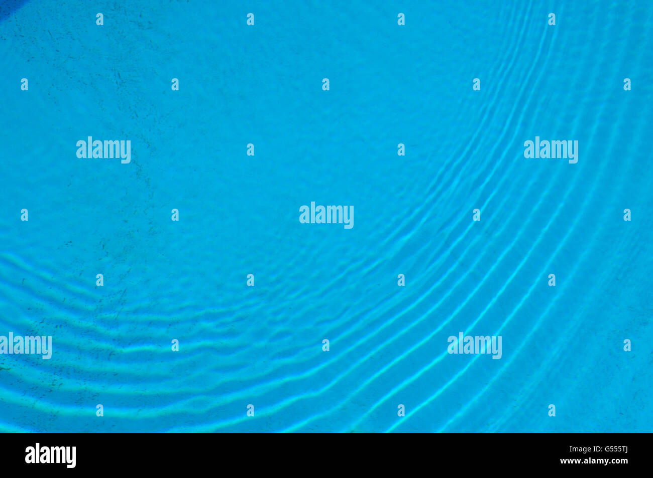 Ripples on a pool of blue water Stock Photo - Alamy