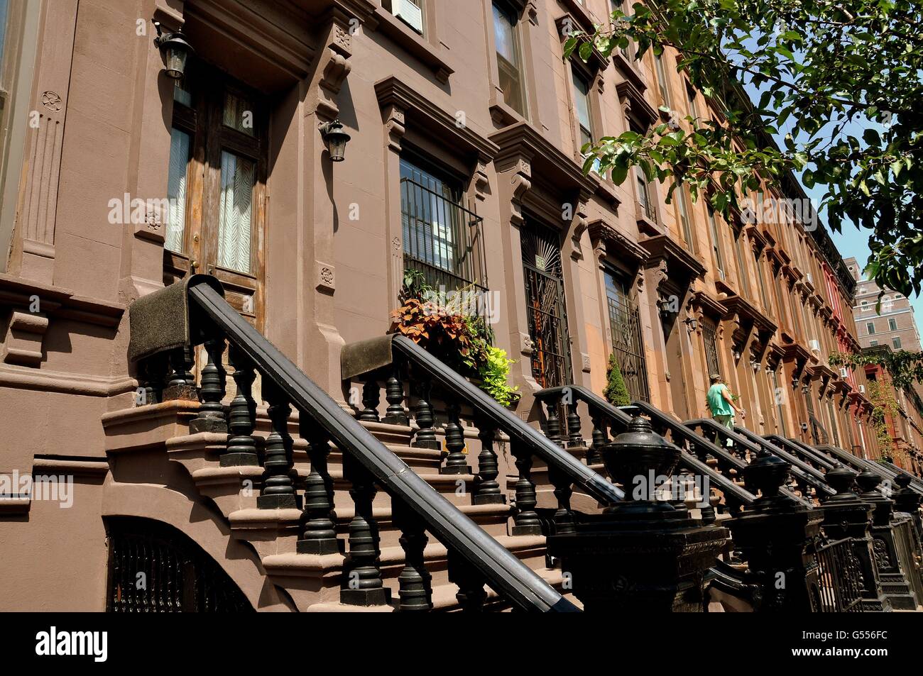 New York City:  Early 20th century brownstones with high stoops on Manhattan Avenue at West 121st Street in Harlem Stock Photo