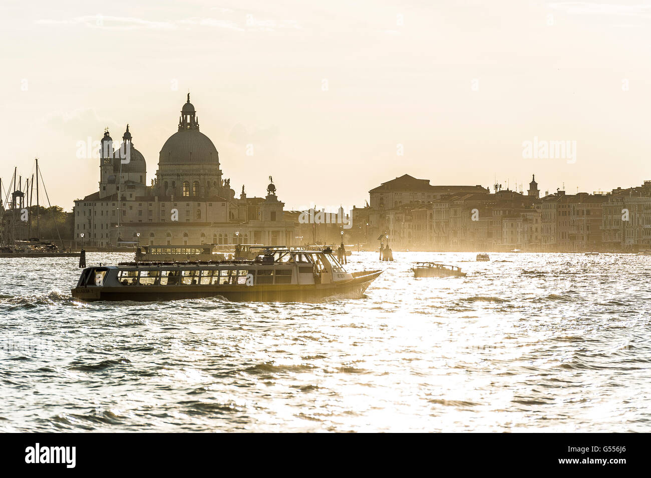 vaporetto water taxi on the Grand Canal at sunset Venice Stock Photo
