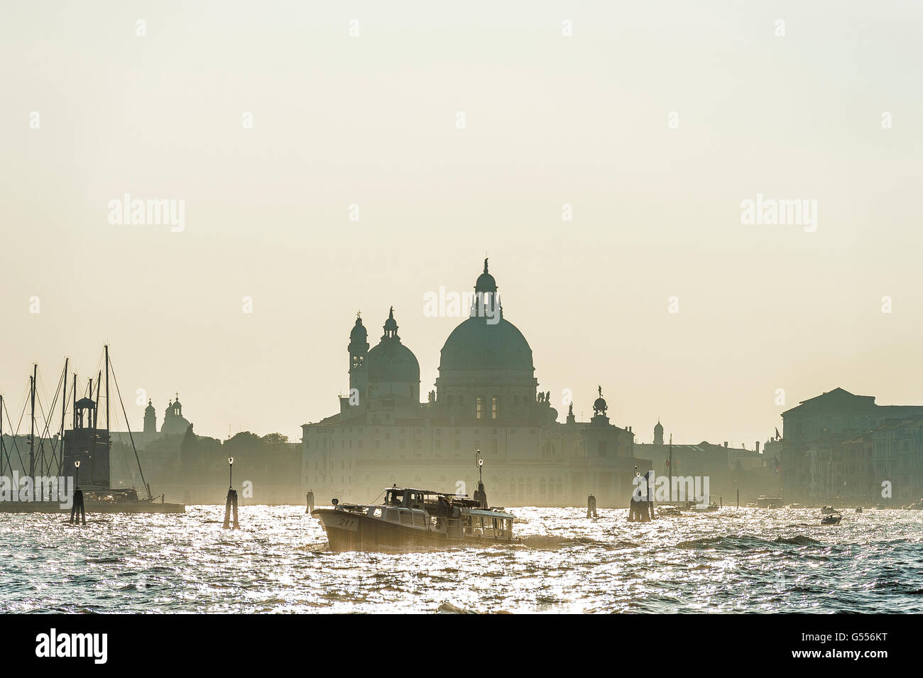 Vaporetto and ferries on the Grand Canal with Basilica Benedictine in the background Venice Stock Photo