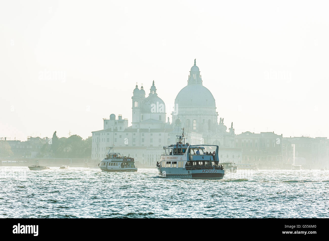 Vaporetto and ferries on the Grand Canal with Basilica Benedictine in the background Venice Stock Photo