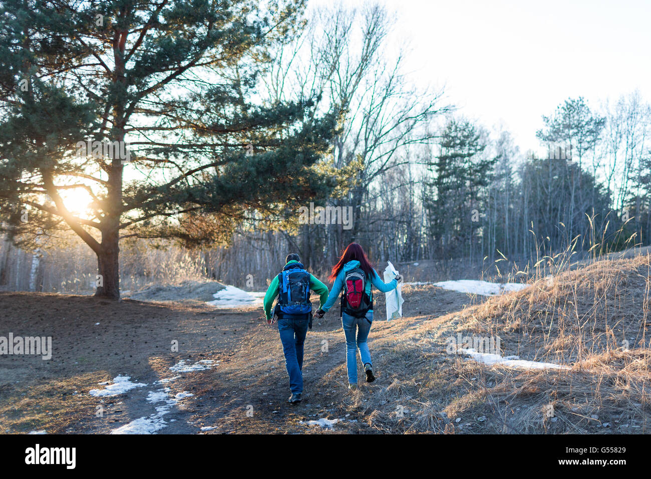 Hiking Couple In Spring Forest Outdoor Adventures Concept Stock Photo